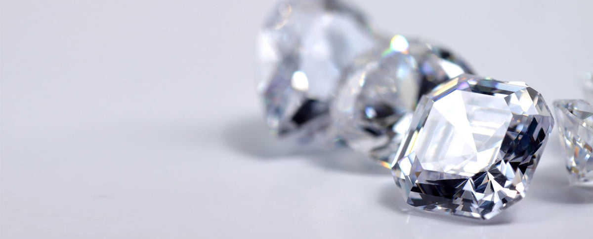 Loose diamonds on a pale surface