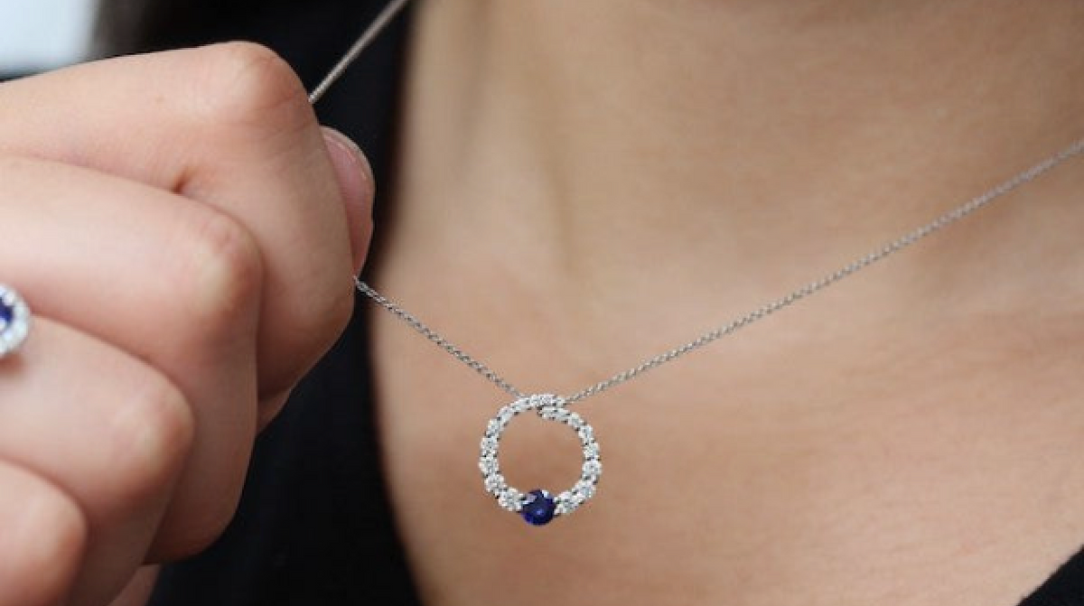 A custom-made diamond pendant worn at the neckline