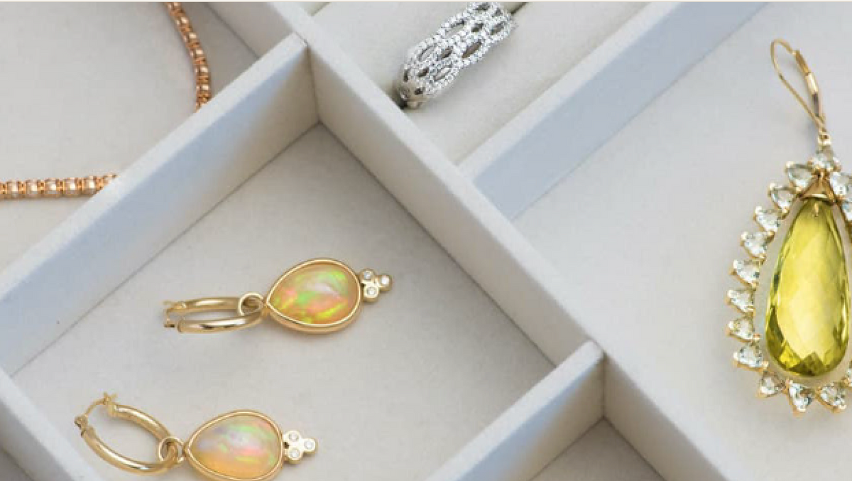 A tray of gold and gemstone jewelry laid out for inspection and care